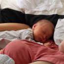 Ein neugeborenes Baby liegt im Arm seiner Mutter